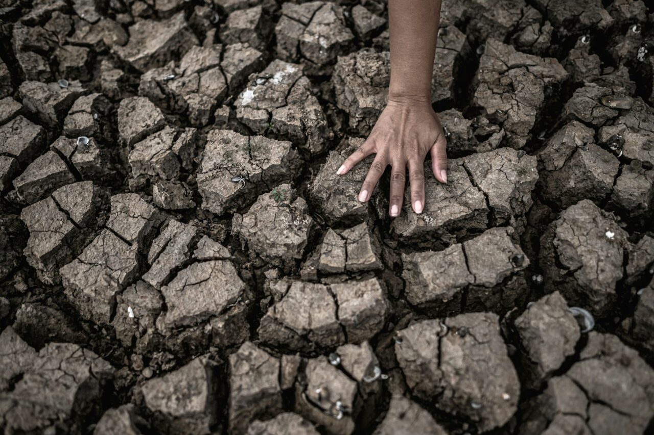 Hands on dry ground,Global warming and water crisis