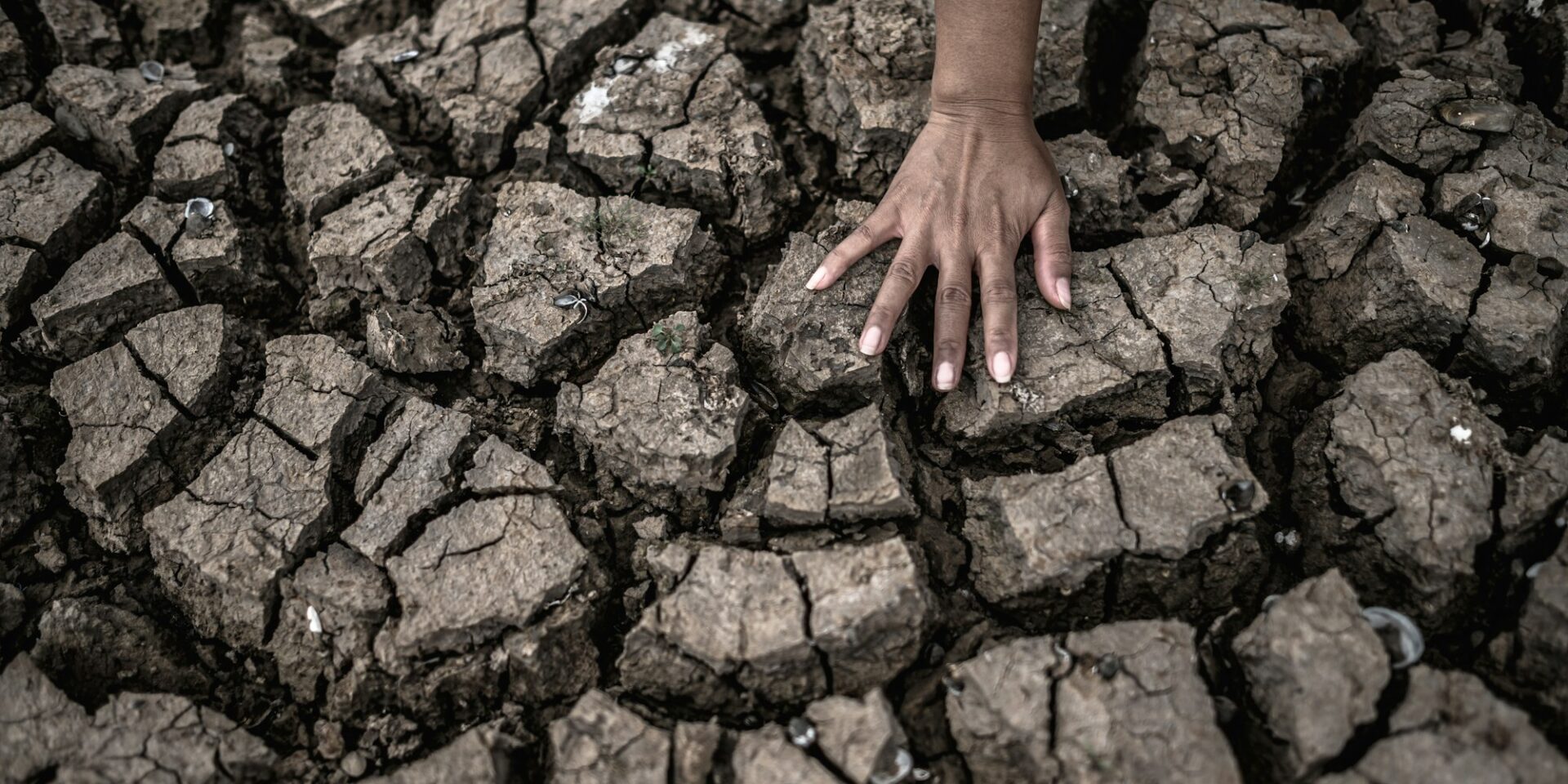 Hands on dry ground,Global warming and water crisis